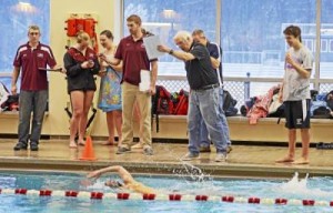 Radnor swimming coach Tom Robinson (in black), offers encouragement. (Tom Kelly IV)