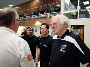 Radnor High School swim coach Tom Robinson, right, talks with officials before the start of a swim meet. (For the Inquirer/Joseph Kaczmarek) 