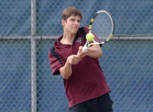 Radnor's Josh Taylor smacks a backhand return during his 6-0, 6-1 victory over Unionville s Zack Sokoloff at second singles that helped the Raiders claim a 3-2 victory in the District One Class AAA quarterfinal match Tuesday. (Tom Kelly IV)